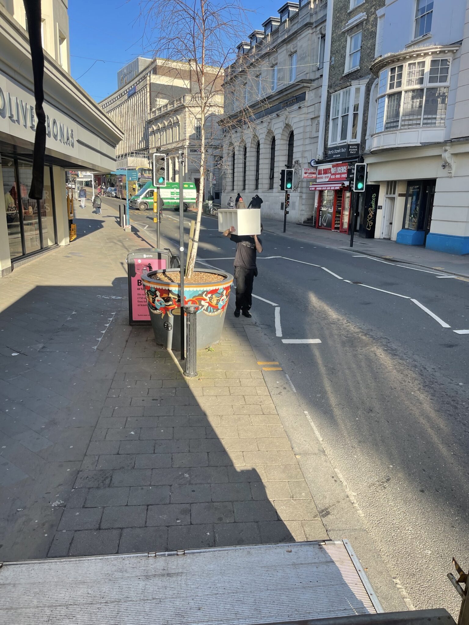 ESV Removals team member carrying a boxed item across Brighton city centre near North Street while loading for a same day Brighton to Manchester move.