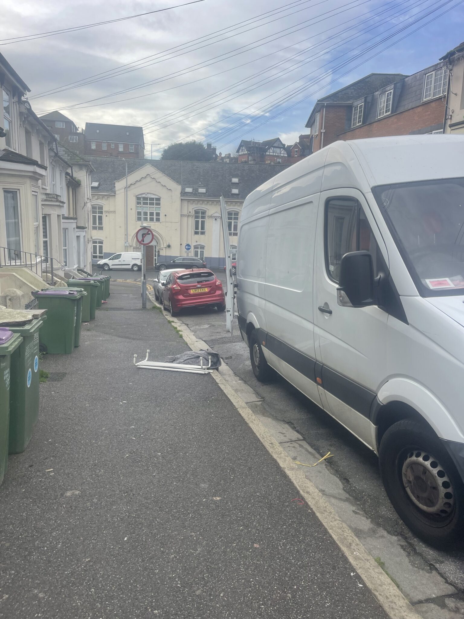 White Mercedes Sprinter parked on a narrow residential street in Folkestone while loading for a one room move to East Sussex.