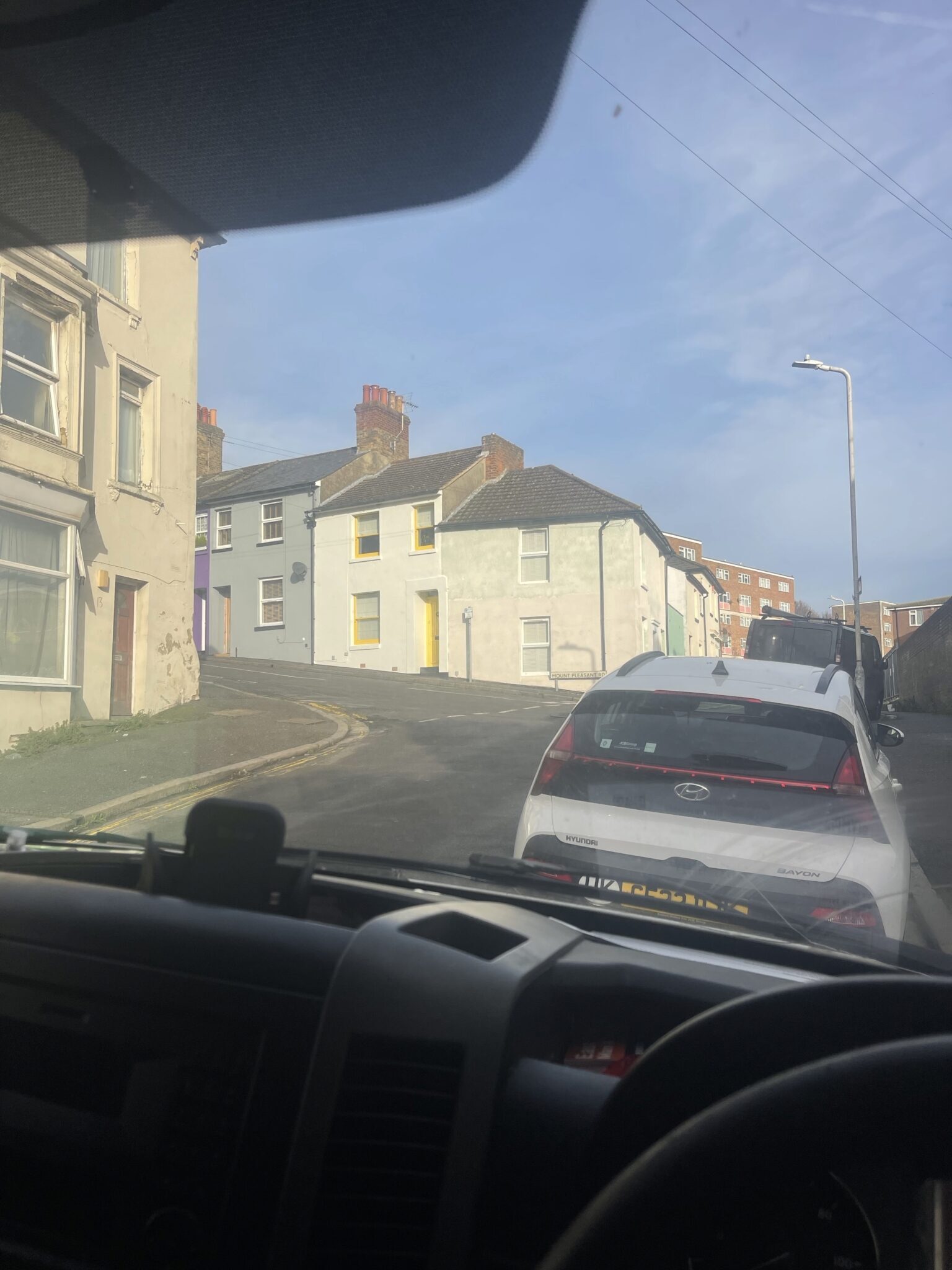 View from the drivers seat of the removals van on a steep street in Folkestone at the start of a Brighton and Sussex man and van journey.