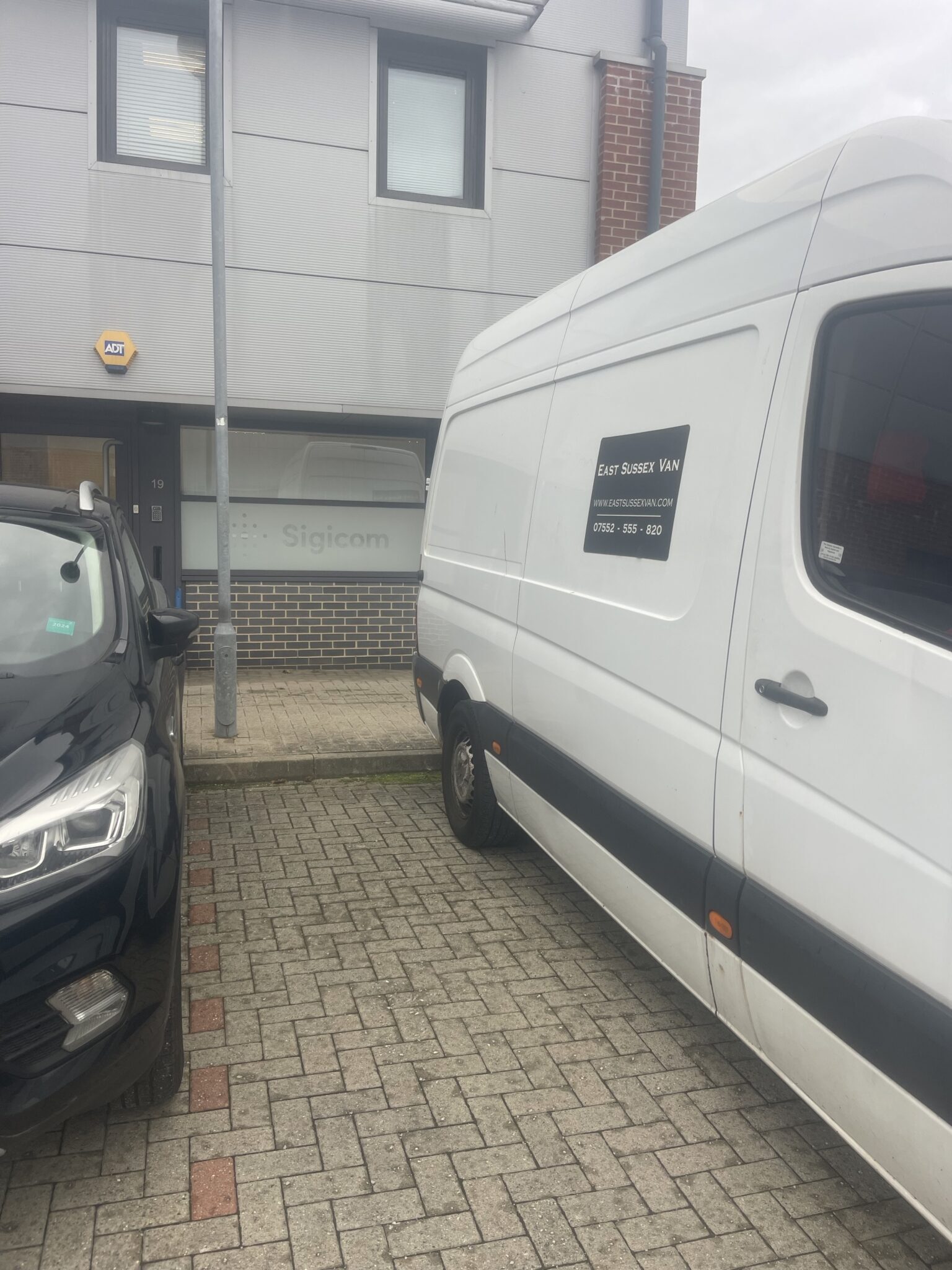 White East Sussex Van parked in front of Sigicom’s office building in Horsham, West Sussex, before transporting equipment to a London Olympia exhibition.