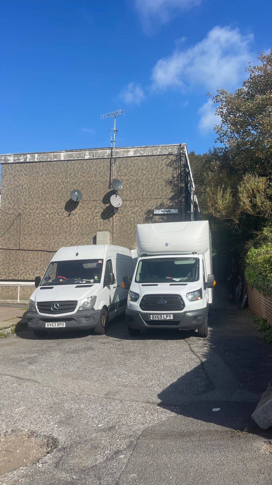 ESV Removals Ford Transit Luton and Mercedes Sprinter parked side by side on the forecourt of a block of flats
