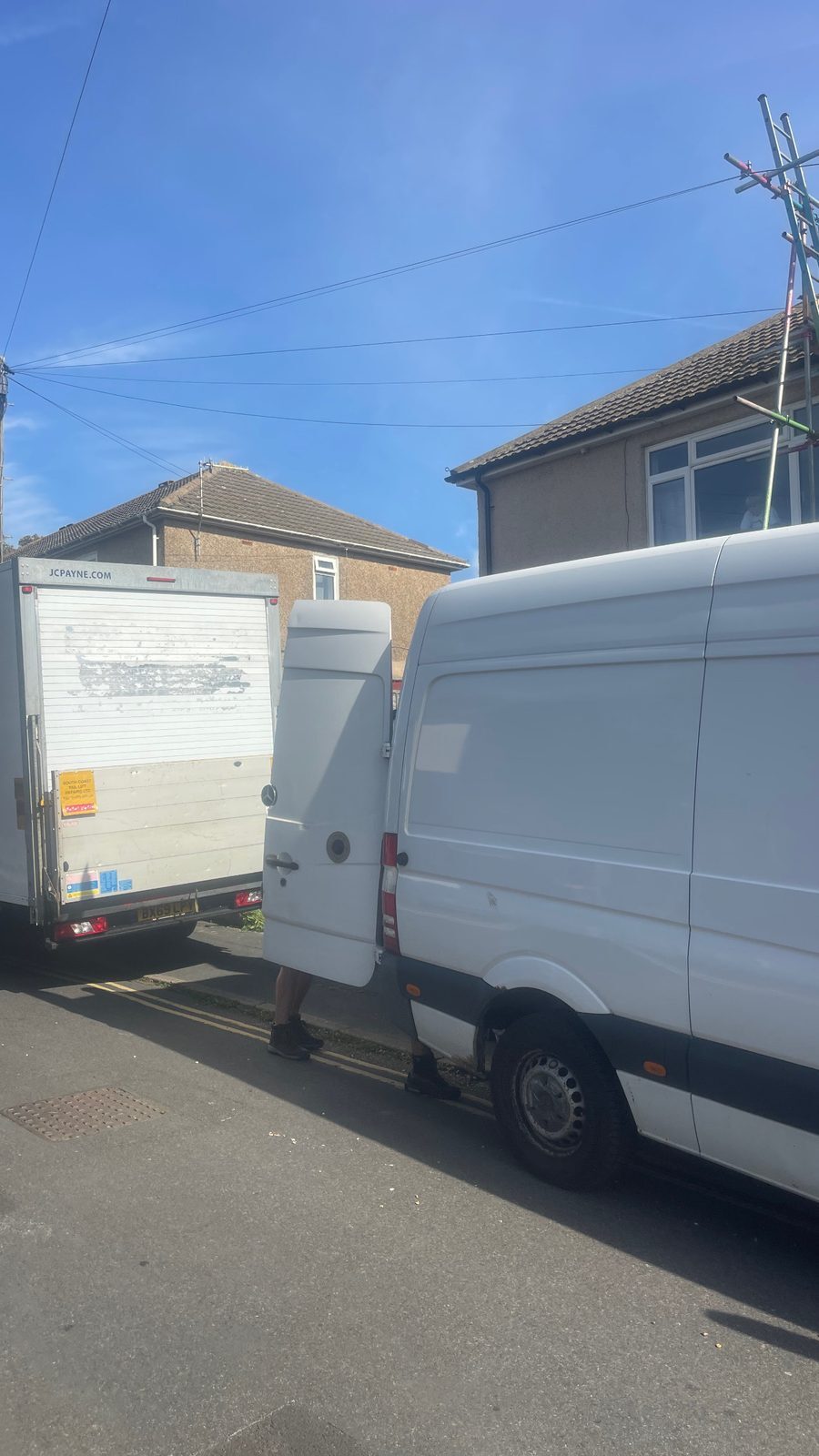 ESV Removals Ford Transit Luton and Mercedes Sprinter loading along double yellow lines on a residential street