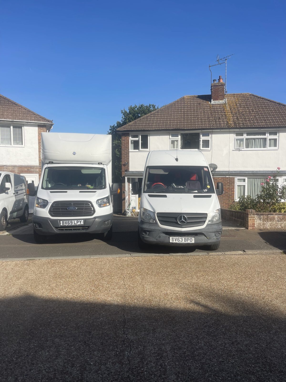 ESV Removals Ford Transit Luton and Mercedes Sprinter parked side by side outside a semi-detached house